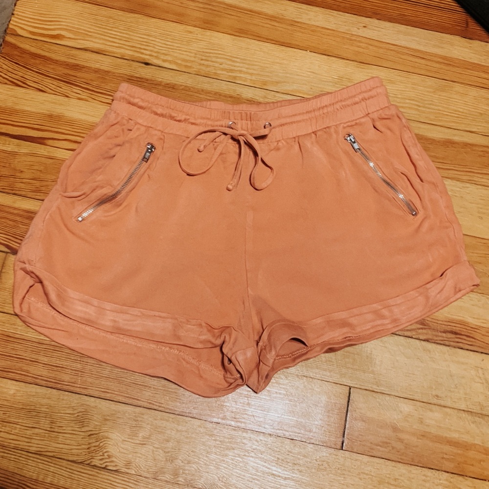 Pink Shorts with Gold Zipper pockets.